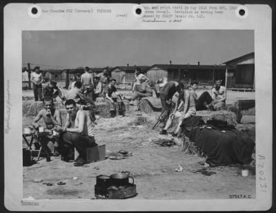 Thumbnail for Consolidated > Straw Is A Luxury To These Allied Prisoners In A German Prison Camp.  Along With Tables To Eat On, Another Sign Of Freedom Was Straw For Mattresses -- A Luxury After Having Slept On Gravel Floors. Red Cross Packages, Despite Erratic Delivery By German Tra