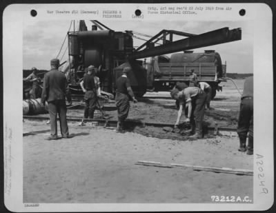 Thumbnail for Consolidated > German Prisoners Of War Working On The Taxiway At An Airfield Somewhere In Germany.  Note The Cement Mixer In Background.  5 June 1945.