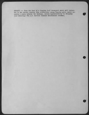 Consolidated > Germany -- From The Door Of A Douglas C-47 Transport Which Wil Return Her To Her Native Country This Attractice, Young Russian Girl, Until Recently A Slave Laborer For Germans, Smiles Appreciatively To Friendly (And Admiring) 9Th Af Service Command Mainte