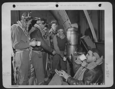 Consolidated > In fighting togs, these Marauder-men-members of the crew of the Martin B-26 Marauder medium bomber, "Sad Sack" get a final tune-up around the coffee pot in their crew room. Hot coffee and biscuits "Down the hatch," these fliers took off a few minutes