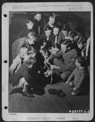 Thumbnail for Consolidated > Kids are kids, wherever they may be--and no one knows it better than Cpl. Glen D. Hunt, ofrmer Seattle assistant Scoutmaster who teaches an English Cub pact the mysteries of knot-tying. Hunt, a Chemical Warfare expert with the Air Service Command