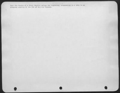 Consolidated > Onto the Cradle of a Giant Trailer swings the Lightning, preparatory to a trip to an advanced station of the 8th AF Service Command.