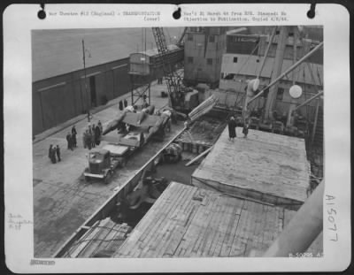 Consolidated > Overall shot of P-38 unloaded onto the Quay of a giant trailer of the 8th AF Service Command.