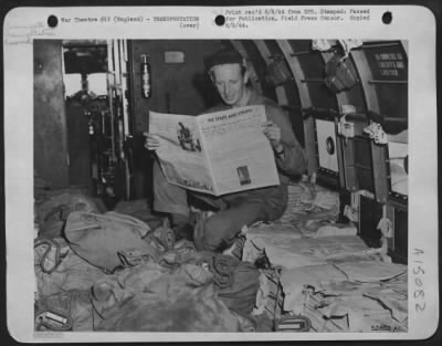 Thumbnail for Consolidated > Crew Chief Sgt. W. H. Banks in a 9th Air force transport plane reads a copy of Stars and Stripes Army newspaper, as copies of the paper are flown from England to France in Douglas C-53's.