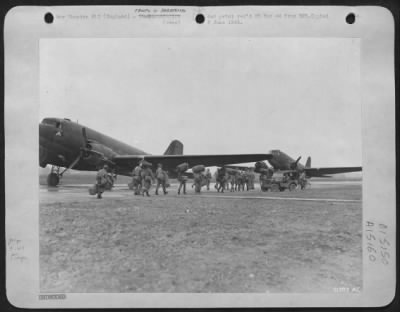 Thumbnail for Consolidated > Each man toting his own equipment, these 9th AF Service Command airborne technicians trudge down the runway toward transport planes waiting to whip them far up forward and set them down uponn advanced air bases in Great Britain-eventually, uponn