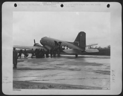 Consolidated > Hustling to find their places, 9th AF Command technicians queue up beside the last of several Douglas C-47 transport planes which will carry an Advanced 9th AF station in Great Britain. America's flying "fixits" have now been trained, armed and