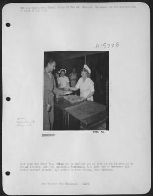 Thumbnail for Consolidated > Just like Mom bakes 'em. WACS now in England are on duty in the kitchen of an 8th AF Station. Sgt. Wm. Ziminski, Hempstead, N.Y. gets one of Bakeress T-5 Averil Curtis' Do-nuts. T/5 Curtis is from Weston, West Virginia.