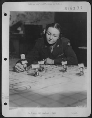 Thumbnail for Consolidated > Pvt. Elizabeth K. Hamilton is plotting the courses of bombers over England as they take off on another mission.