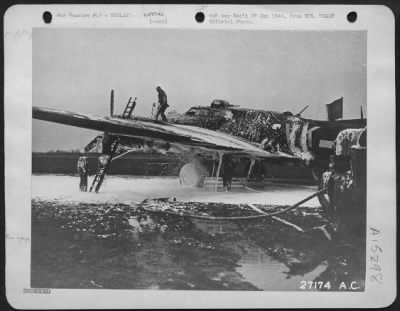 Thumbnail for Consolidated > Ground crew extinguishes fire on crashlanded ofrt (Boeing B-17) piloted by 2nd Lt. Jack W. Watson, Indianapolis, who all alone, brought ship back from 8th AF attack on Oschersleben, 11 Jan 1944, after he ordered crew to bail out when plane caught