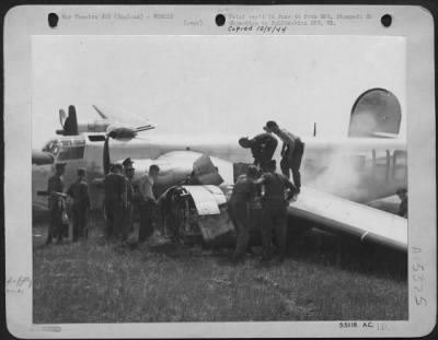 Thumbnail for Consolidated > FLAK DAMAGED CONSOLIDATED B-24 LIBERATOR CRASH LANDS---Fire fighting personnel are shown smothering flames which threatened to envelop Consolidated B-24 Liberator "Zeus," piloted by 2nd Lt. Lester J. Baer, Elk River, Minn.