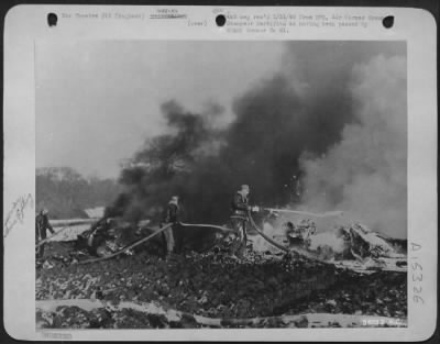 Thumbnail for Consolidated > Fire fighters, on the job 24 hours a day at this Eighth Air force Boeing B-17 Flying ofrtress station, are pictured here extinguishing the flames from a burning ofrtress which crashed near this airfield. The stricken ofrtress exploded shortly after