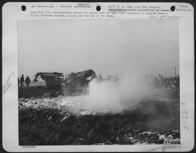 Thumbnail for Consolidated > ofam from fire extinguishers covers the plowed soil of this field somewhere in England where a Flying ofrtress crashed, killing all but one of its crew.