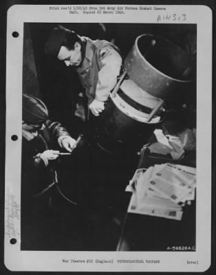 Consolidated > Capt. John V. Keck, Ordnance Officer At The Chelveston Air Base Designed And Constructed An Inexpensive Bomb, Using M-76, 500 Lb. Cluster Bomb Casing, To Facilitate And Improve The Accuracy Of Propaganda Leaflet Bombing.  Shown Here Are Two Ordnance Men L