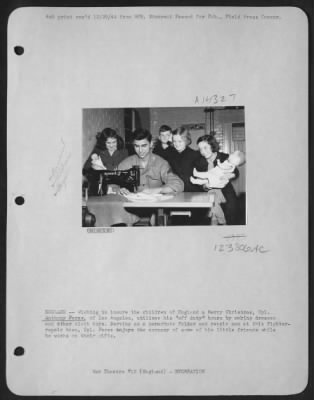 Consolidated > England -- Wishing To Insure The Children Of England A Merry Christmas, Cpl. Anthony Perez, Of Los Angeles, Utilizes His 'Off Duty' Hours By Making Dresses And Other Clothe Toys. Serving As A Parachute Folder And Repair Man At This Fighter-Repair Base, Cp