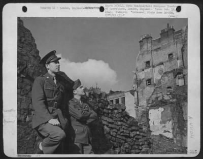 Thumbnail for Consolidated > Pvt. Frank H. Phillips, Utica, Ny (Left), And Clp. Graham T. Wheeler, Durham, Nc, Felt The Gravity Of The War As They Visited Bombed Areas Shortly After Their Arrival In England.  London, England.