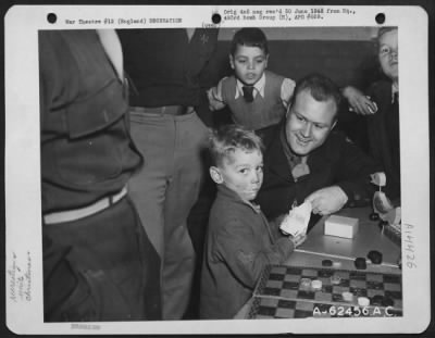 Thumbnail for Consolidated > Members Of The 493Rd Bomb Group Give English Children A Glimpse Of Old St. Nick At A Special Christmas Party Given At An U.S. Airbase In England, 22 December 1944.