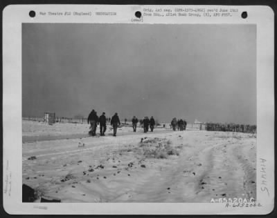 Thumbnail for Consolidated > Men Who Have Had Chow And Are Going Back To Work On The Boeing B-17 Flying Fortresses Of The 401St Bomb Group Meet Fellow Workers Who Are Walking Along 'Chow Hall Road' Toward The Mess Hall.  England, 28 January 1945.