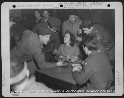 Thumbnail for Consolidated > Ella Logan, A Member Of A U.S.O. Troupe, Signs Short Snorters For Men At 1St Combat Crew Replacement Center, Aaf Station 112 In England, 21 February 1944.