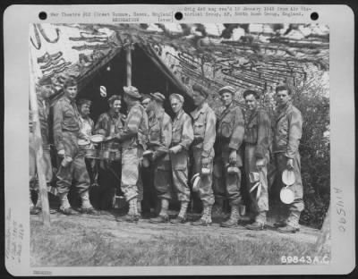 Thumbnail for Consolidated > Men Of Co. D Det., 555Th Signal Air Wing, 386Th Bomb Group Stand In Line And Wait Their Turn To Be Served By Mess Personnel At Their Base In Great Dunmow, Essex, England On 8 May 1944.