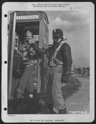 Thumbnail for Consolidated > 2Nd Lt. John A. Moeller, Oakland, Calif (Left) And S/Sgt. Robert S. Elroy, Los Angeles, Calif., Debate Who Will Use The Telephone First, At An Air Base In England, After Their Return From A Mission Over Germany.