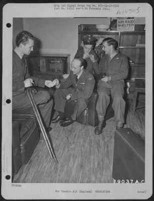 Thumbnail for Consolidated > Listening To The War News From Tunisia, These Men Are In The Famous American Eagle Club In London, England.  This Club Was Started By American Airmen Stationed In England.  The Men Are, Left To Right: F/O Richard E. Mohan Of Pocatello, Idaho, Rcaf Pilot;