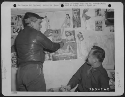 Thumbnail for Consolidated > 1St Lt. Don Bader Of Edison, Ohio Adds Another Pin-Up Picture To His Gallery While Capt. Charles E. Cliburn Of Hazelhurst, Miss., Looks On At Their Base At Cambridge, England.  6 May 1943.