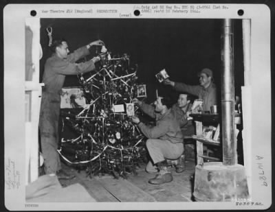 Consolidated > These Gis Attached To The 9Th Service Command Somewhere In England, Take Time Out On Christmas Eve To Decorate A Tree At Their Base.  They Are, Left To Right: Pvt. George Rutter Of Greenburg, Pa., Cpl. Conrad Myers Of Fort Thomas, Ky., Cpl. Merrill Dunn O