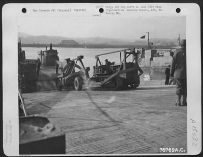 Consolidated > Members Of The 834Th Engineer Aviation Battalion Load Equipment Aboard A Landing Craft During Amphibious Training At Torquay, England.