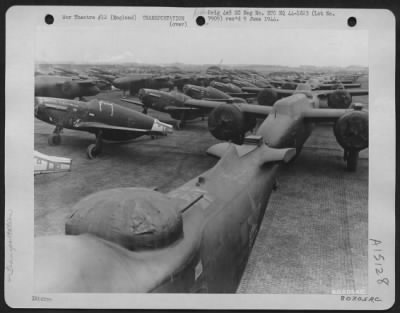 Consolidated > North American P-51S And Douglas A-20S Are Lined Up On The Dock At Liverpool, England After They Were Unloaded From A Ship Which Transported Them From The United States.  29 February 1944.  Republic P-47S In Background.