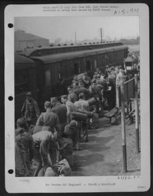 Thumbnail for Consolidated > On The Platform, The Train Guard, Ticket Collector And A U.S. Transportation Corpsman Shepherd The Men And Their Bulky Equipment Aboard.  This Is One Journey They Will All Agree Is 'Really Necessary'.  This Train Will Take Them To Greenock, Scotland, Wher