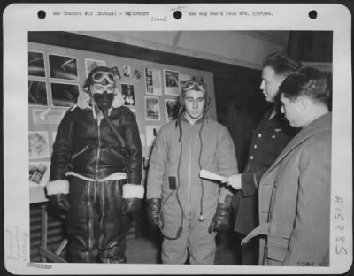 Thumbnail for General > Fur lined vs. Electrically heated, flying suits, Maj. Frank Cleary, St. Louis, Mo. Points out to crack Marauder pilot 1st Lt. Arthur Smith, Buffalo, N.Y. the differences between the fur-lined flying suit and the electrically heated one.