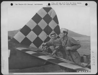 Thumbnail for General > Sgt. Robert E. Eruesale, Bay City, Mich., (Left) And S/Sgt. Cornelius J. Crogin, Lawrence, Miss., Paint The Tail Of A Plane At An Air Base Somewhere In Europe.