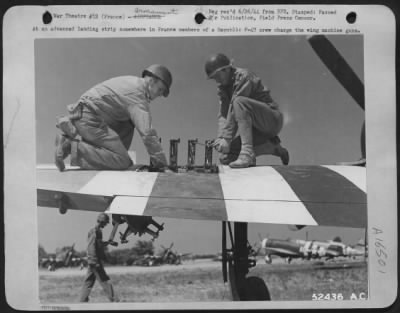 Thumbnail for General > At an advanced landing strip somewhere in France members of a Republic P-47 crew charge the wing machine guns.