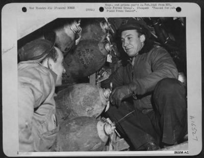 Thumbnail for General > Capt. William E. Smith (now Maj.), right and his crew chief, Sgt. Herman T. Levy, 828 McBride St., Syracuse, N.Y., examine the bombs load of "Rat Poison" just before the Martin B-26 Marauder takes off on its 164th mission. FRANCE.