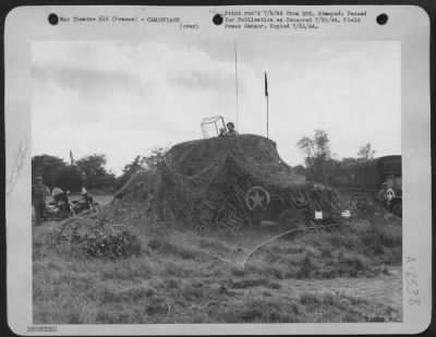 Thumbnail for General > Carefully camouflaged, this mobile control tower directs incoming and outgoing traffic at the first American airfield in Normandy. The field, built by members of the 9th Engineer Command, is already in operation refueling and servicing fighters