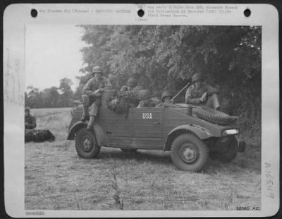 Thumbnail for General > "Somewhere in France," Pvt. Lavern Bick, Joliet, Ill., Cpl. Bill Stone, Heleyville, Ala; Pvt. Joe Spinner, Indiana, Pa., Sgt. Lee C. Draus, Malone, Wisc., and S/Sgt. John B. Upchurch of Fayetteville, N.C., in a German jeep. The American Star