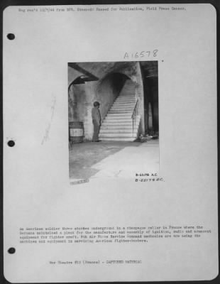 Thumbnail for General > An American soldier three stories underground in a champagne cellar in France where the Germans maintained a plant for the manufacture and assembly of ignition, radio and armament equipment for fighter draft. 9th Air force Service Command mechanics