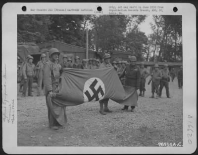 Thumbnail for General > Colonel Mccavley, Air Corps, Colonel Karl B. Shilling, Corps Of Engineers, And Major General Ralph Royce Hold Up A Nazi Flag Which Was Captured By Men Of The 834Th Engineer Aviation Battalion At St. Pierre Du Mont, Normandy, France.