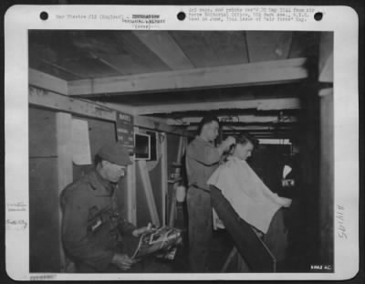 General > This is not Shantytown but a place somewhere in England that the boys call Crate City. Buildings are made of glider packing cases. The barber shop once covered glider parts.