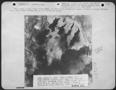 Thumbnail for Consolidated > AFHQ, August 1, 1943-Huge columns smoke rise from burning planes & oil dumps on Leverano Airfield, Southern Italy, after recent fortress raid by N.W. African Air Forces.