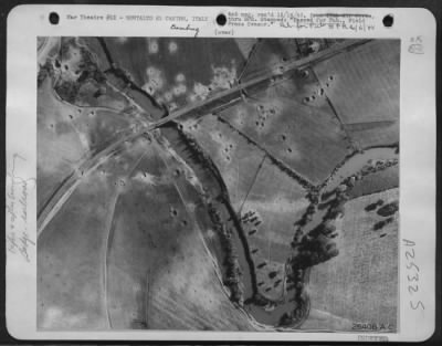 Thumbnail for Consolidated > FROM ADVANCED BOMBER BASE November 13--Two aerial photographs give clear picture of how American Marauder bombers are clipping the German supply lines in Italy. The first picture shows the Fiera River Railroad bridge near Montalto di