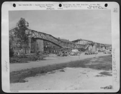 Consolidated > Many Axis planes were destroyed in the hangars at Capiodichino Airfield, near Naples by the bombers of the Northwest African Air Forces. This picture shows one of the battered hangars.