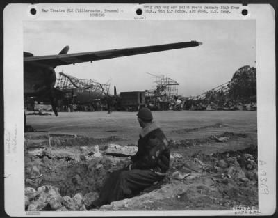 Thumbnail for Villaroche > A Gi Sits In A Partially Filled Bomb Crater As He Looks Over A Section Of German Base Which Is Now Operated By (Douglas A-20 'Havoc') 416Th Bomb Group.  Villarouche, France.  2 October 1944.