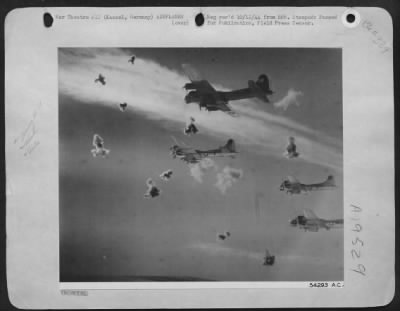 Flak > Bursts of deadly flak explode around a formation of Boeing B-17 Flying Fortresses of the 8th U.S. Air Force during one of their recent missions over Kassel, Germany. The flak appears as innocent puffs of smoke in this photo, but each burst showers