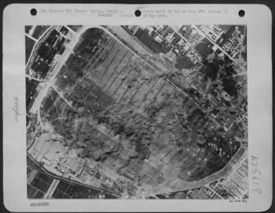 Consolidated > Believed to be a ferry base for planes from German factories, the airdrome at Reggio Emilia, northwest of Florence, Italy, was attacked by Consolidated B-24 Liberators of the 15th AAF on May 14, 1944. Smoke and dust rising from the target area give