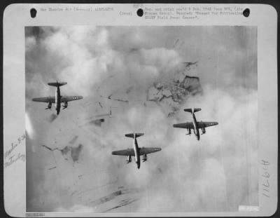 Martin > American Martin B-26 Marauders of the First Tactical Air Force in an encounter with their worst enemy over Germany . . . . The weather! Small breaks in heavy clouds reveal only haze and snow-covered terrain, all obstacles in identifiying landmarks