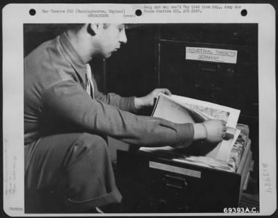 General > Target Maps Of Every City And Industry In Germany Are Kept Ready For Each Special Mission.  Here A Member Of The 91St Bomb Group Stationed In Bassingbourne, England, Gets The Map Out For Men Planning The Next Mission Over Berlin.  25 February 1944.