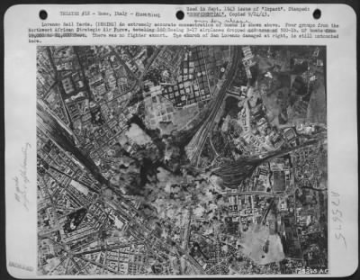 Thumbnail for Consolidated > Lorenzo Rail Yards. (DURING) An extremely accurate concentration of bombs is shown above. Four groups from the Northwest African Strategic Air Force, totaling 150 Boeing B-17 airplanes dropped 442 tons of 500-lb. GP bombs from 19,000