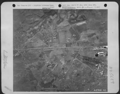 Thumbnail for Consolidated > Arrow points to a cluster of fragmentation bombs just as they have been automatically sheered. Each cluster has 6 bombs and one group of six is seen immediately below the cluster just breaking open. This photo was taken by cameramen in Martin B-26