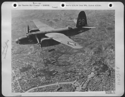 Thumbnail for Consolidated > B-26 Marauder "Little Chum" of Lt. Gen. Ira C. Eaker's Mediterranean Allied Air Forces is shown here in photograph taken from another bomber dropping its deadly load of bombs on the Tiburtina railroad yards in Rome. The plane piloted by 1st Lt.